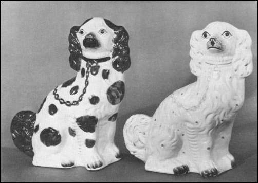 Two typical Staffordshire earthenware dogs of a traditional form made by Kent & Parr