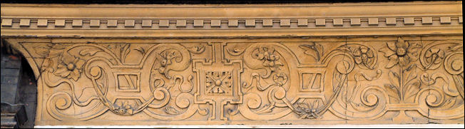 a frieze with decorative relief work runs the whole length of the building façade