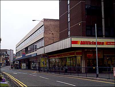 Blackburn House on the far right and a row of shops