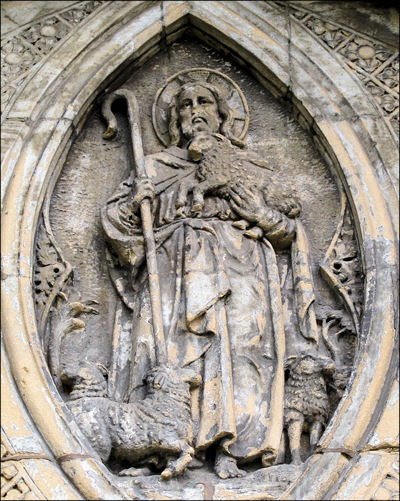 above the main entrance a low relief figure of Christ the Good Shepherd 