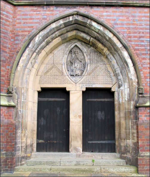 the main entrance with two paired shouldered west doors in a single stone archway