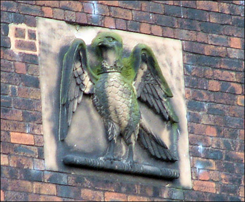 Stone plaque of falcon in gable apex