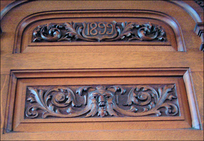 the manufacturing date of 1899 and a carving of a Green Man on the Minster organ 