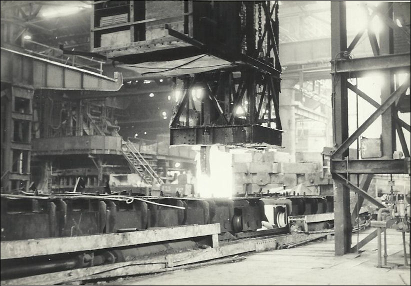 A steel ingot being lifted out of the soaking pit - Shelton Steel Works 