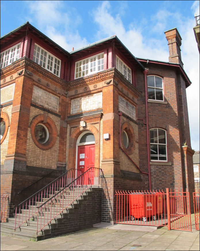 "This impressive building in London Road, Stoke, is the Public Free Library. It is built from a variety of local materials, including red and blue brick, terracotta, and tiles"