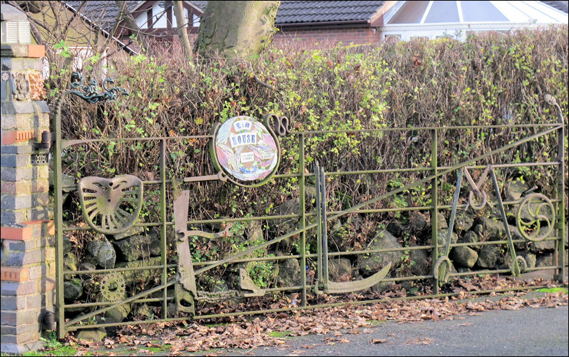 the design of the gate includes farming impliments 