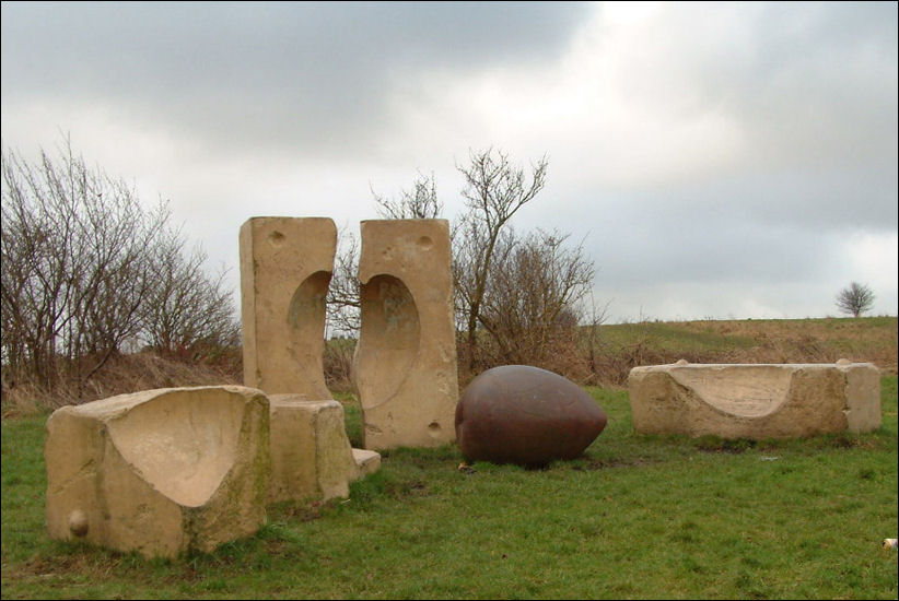 'Breaking the Mould' - five concrete blocks with concave inner surfaces surround an ovoid in steel