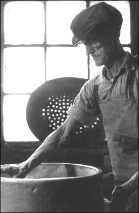 A saggar-maker assembling a base and side.