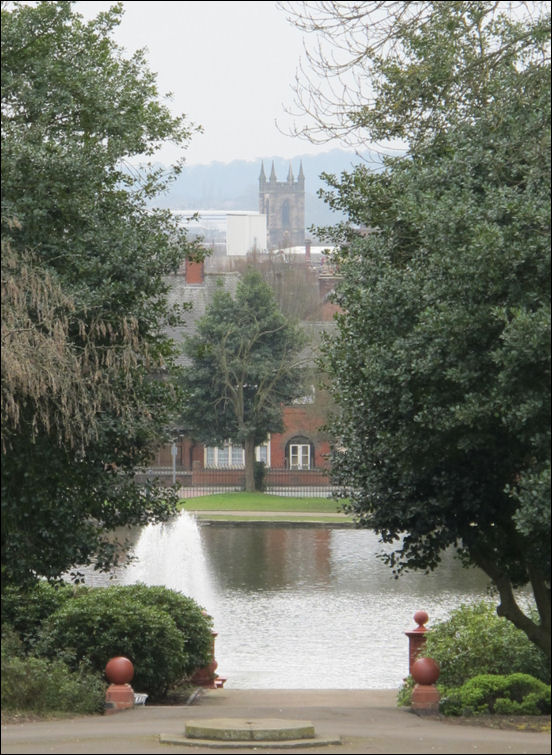 to the south of the bridge is the boating lake and in the distance the tower of Stoke Minster