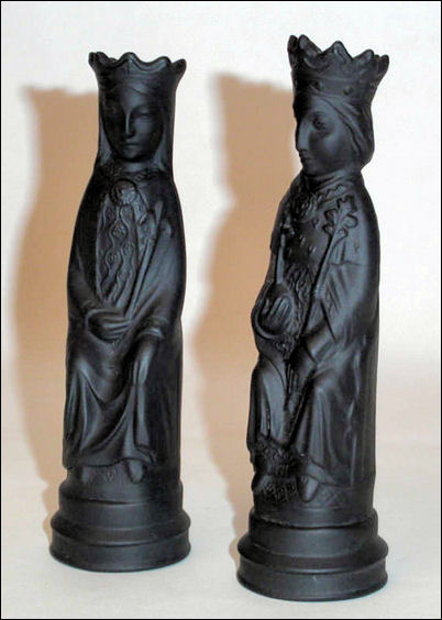 A pair of chess pieces sculpted by Arnold Machin and manufactured by Wedgwood in black basalt.