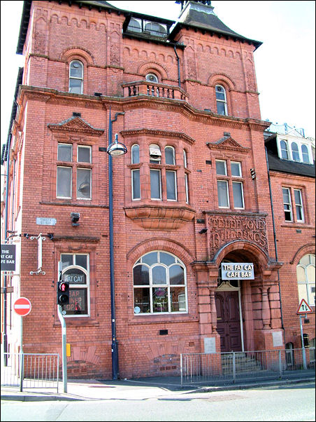 Central segmentally arched window with mullioned and transomed oriel bay over.