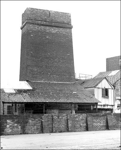 Pottery factory exterior with a view of a calcining kiln. 1975 - 1976 (c.)