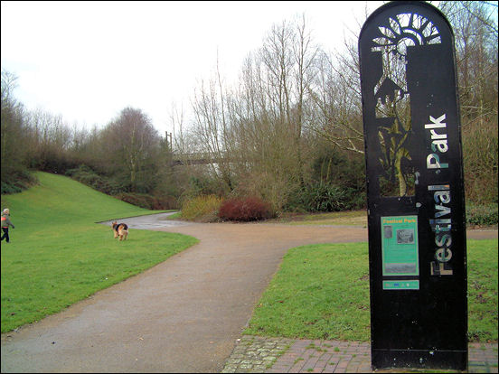 In the background the huge wooden suspension bridge across a wooded ravine