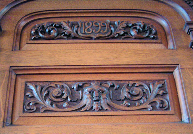 the manufacturing date of 1899 and a carving of a Green Man on the Minster organ 