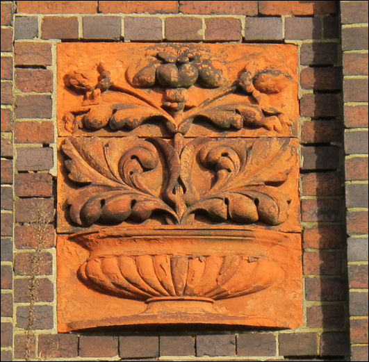 teracotta vase on the apex of the school