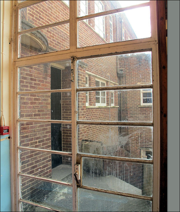 in the corner of the gym - a full hight window with doors 