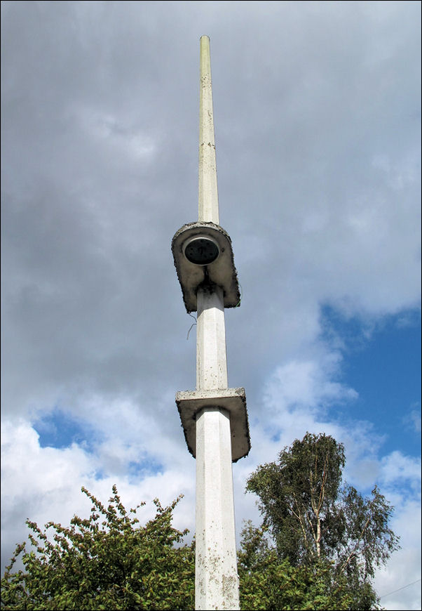 concrete art deco lampost in front of the main entrance 