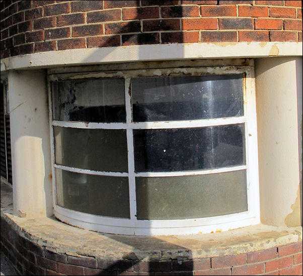 curved and recessed corner steel-framed window with side columns