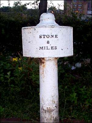 C19, cast iron mile post, cylindrical shaft with domed cap, panelled