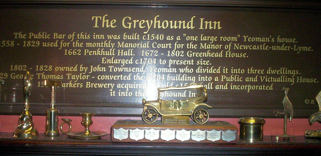 The plaque summarising the history over the fireplace in the lounge