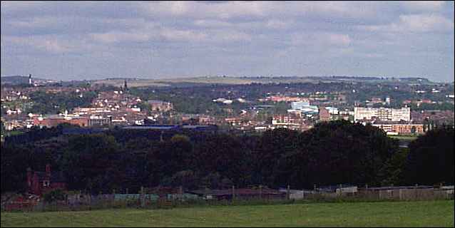In the foreground the trees of Fenton Cemetery, in the mid view to towards the left can be seen the spire of Penkhull Church.