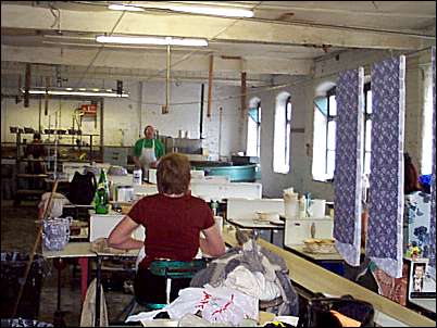 After printing the transfer papers are put onto the overhead pulley wire and sent down the shop for the potters to apply to the ware