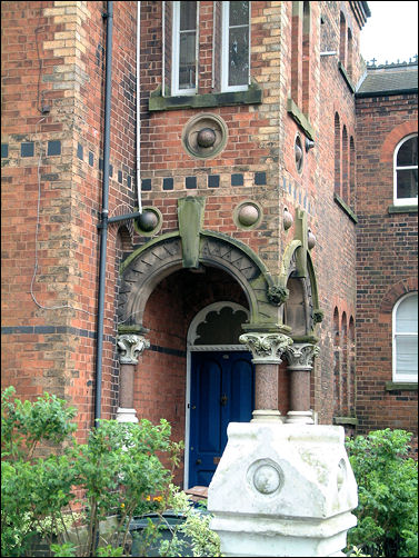 Gothic characteristics of Moneta House with marble globes half-buried in its faade as though the walls had been laid siege-to and pummelled with cannonballs. 