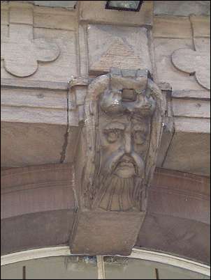 Over the main entrance is a keystone head depicting a mustached man.