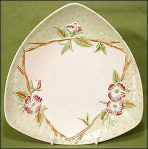 triangular shaped dish with rim feet, and measures 10 ins across.